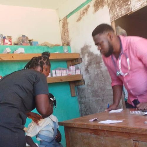 Clinic with doctor and nurse caring for student